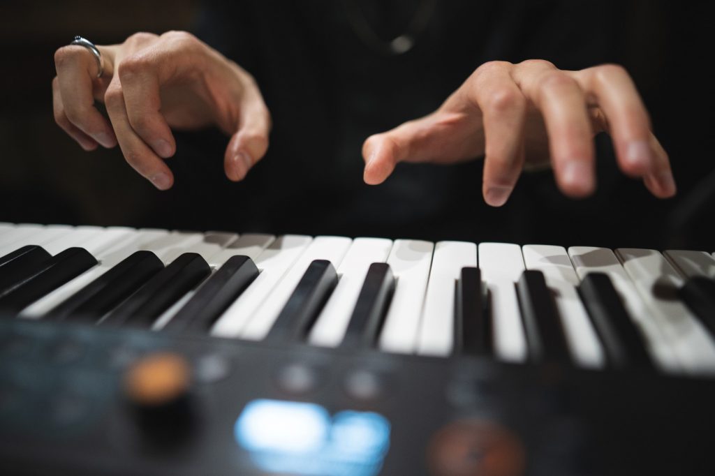 Músico fazendo staccato de braço no piano